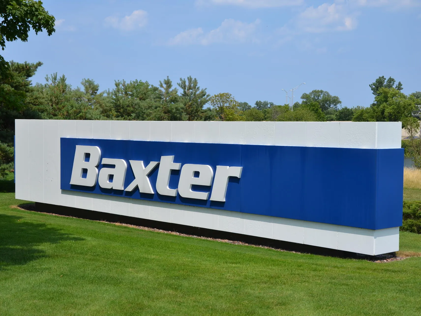 A large outdoor sign with the Baxter Logo